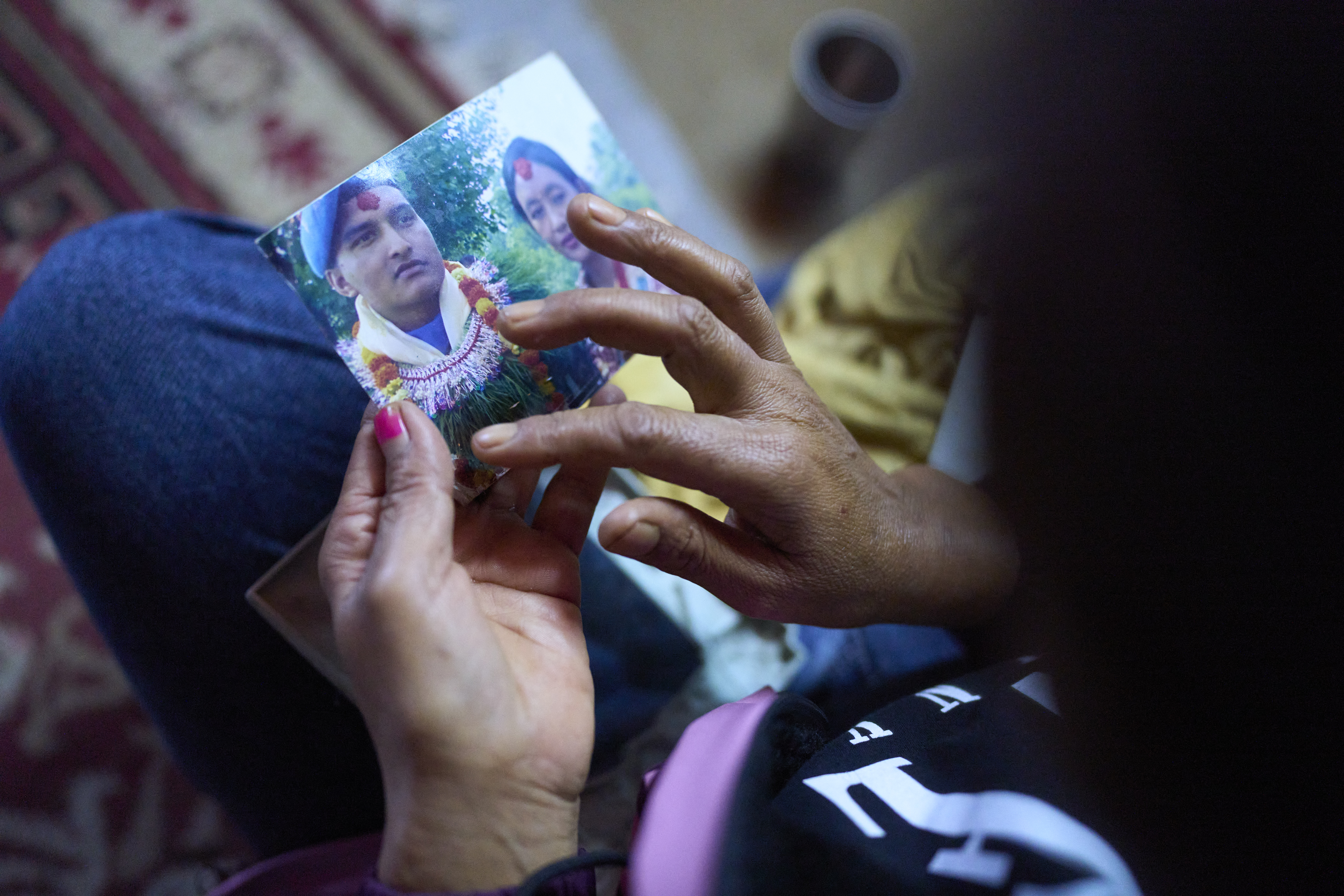 Jeena Lamichane holds a photo of her husband, Ishwor Lamichane, who went missing after traveling to Russia to serve in the Russian army.