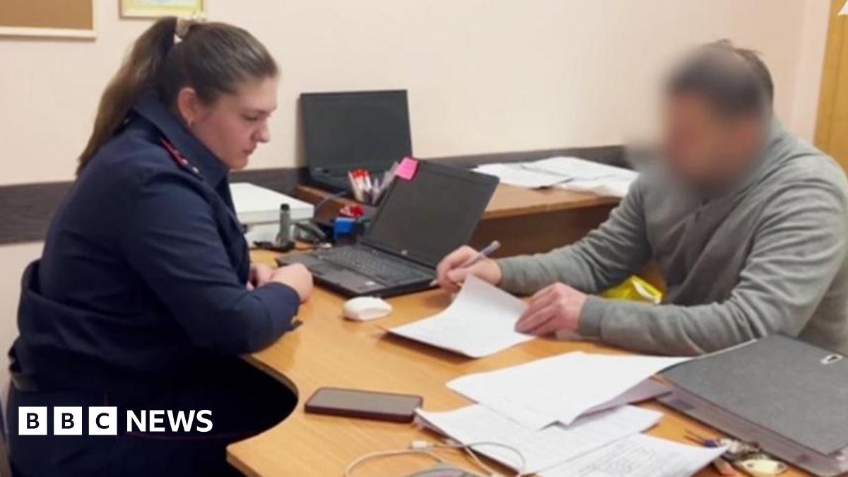 Prime Minister Mark Carney, wearing a black suit jacket, and a white button-up shirt leans his chin on his hands. He has short grey and black hair and is looking away from the camera.