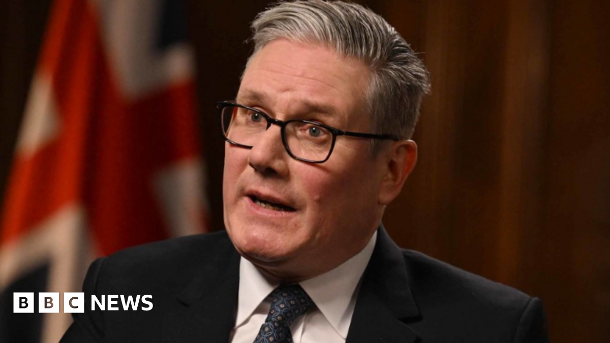 Prime Minister Sir Keir Starmer being interviewed by Laura Kuenssberg for the BBC's Sunday with Laura Kuenssberg programme. He wears a black suit, a white shirt and a navy patterned tie.