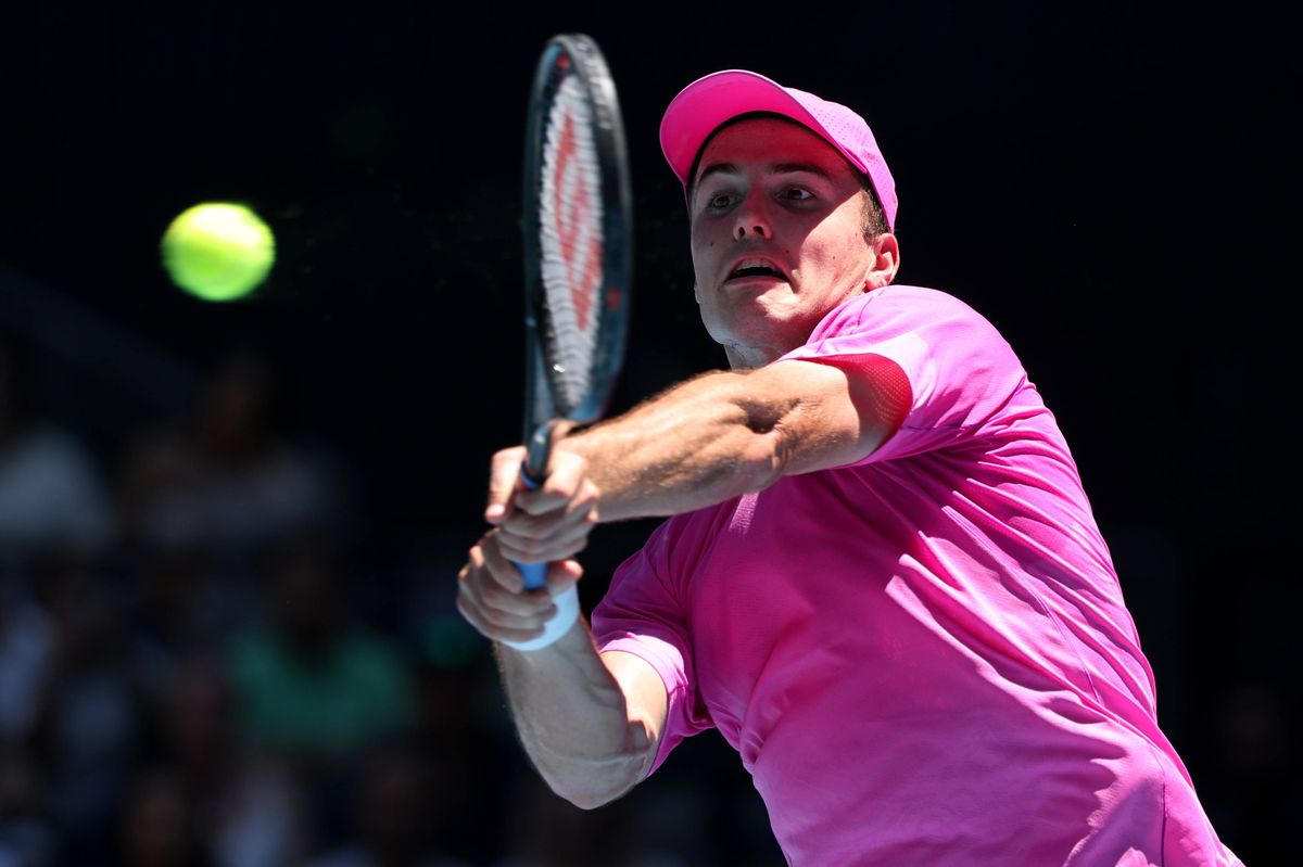 Arthur Fery of Great Britain plays a backhand against Flavio Cobolli of Italy in the Men's Singles First Round during day one of the 2026 Australian Open at Melbourne Park