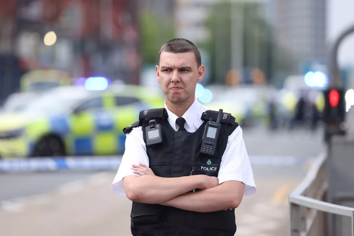 Police at the scene at Low Cost Food and Wine on Stanley Road in Bootle
