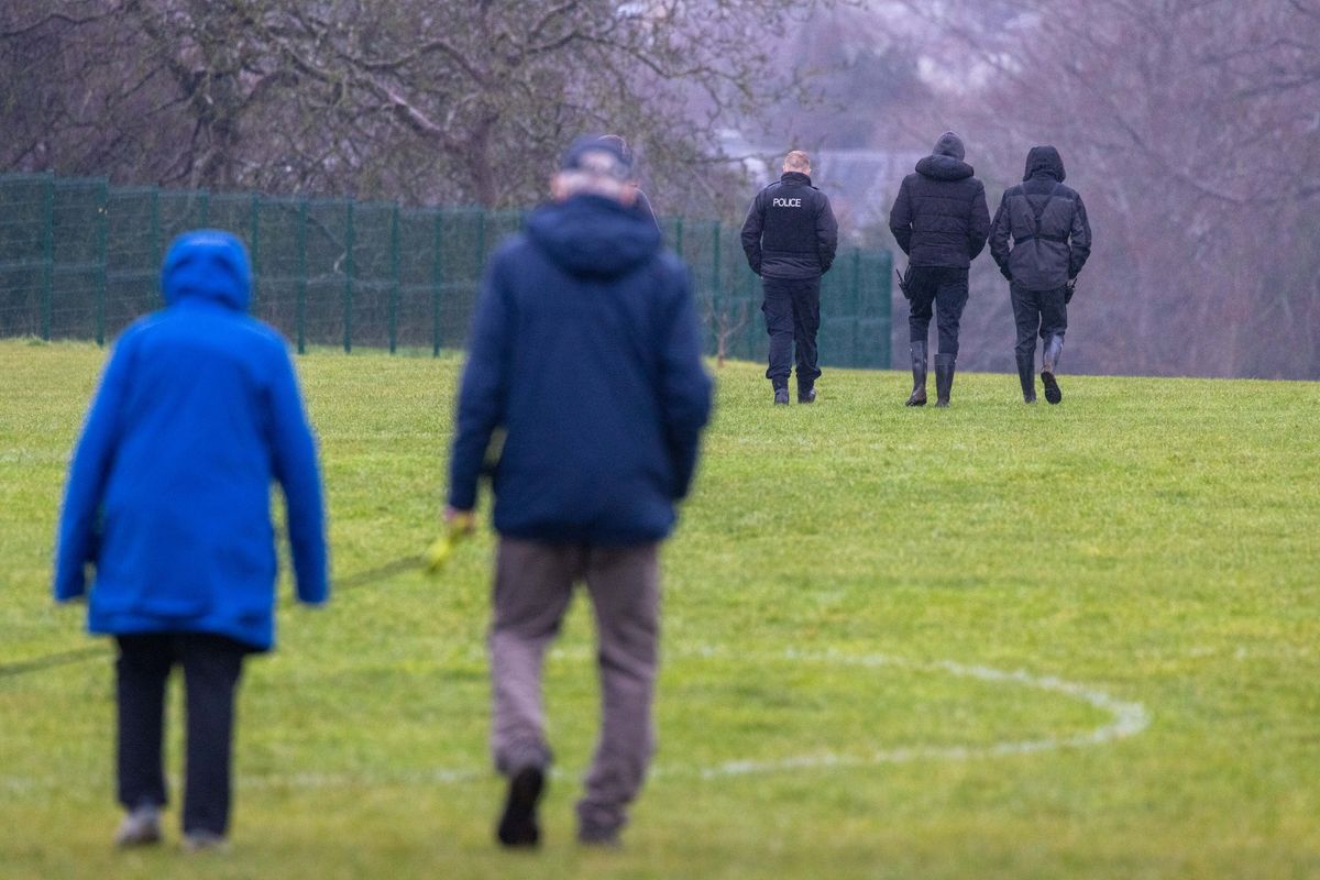 Residents walking public footpaths through Cotham School's playing fields at Stoke Lodge in Bristol, with police, on the morning of Thursday, January 15, 2026