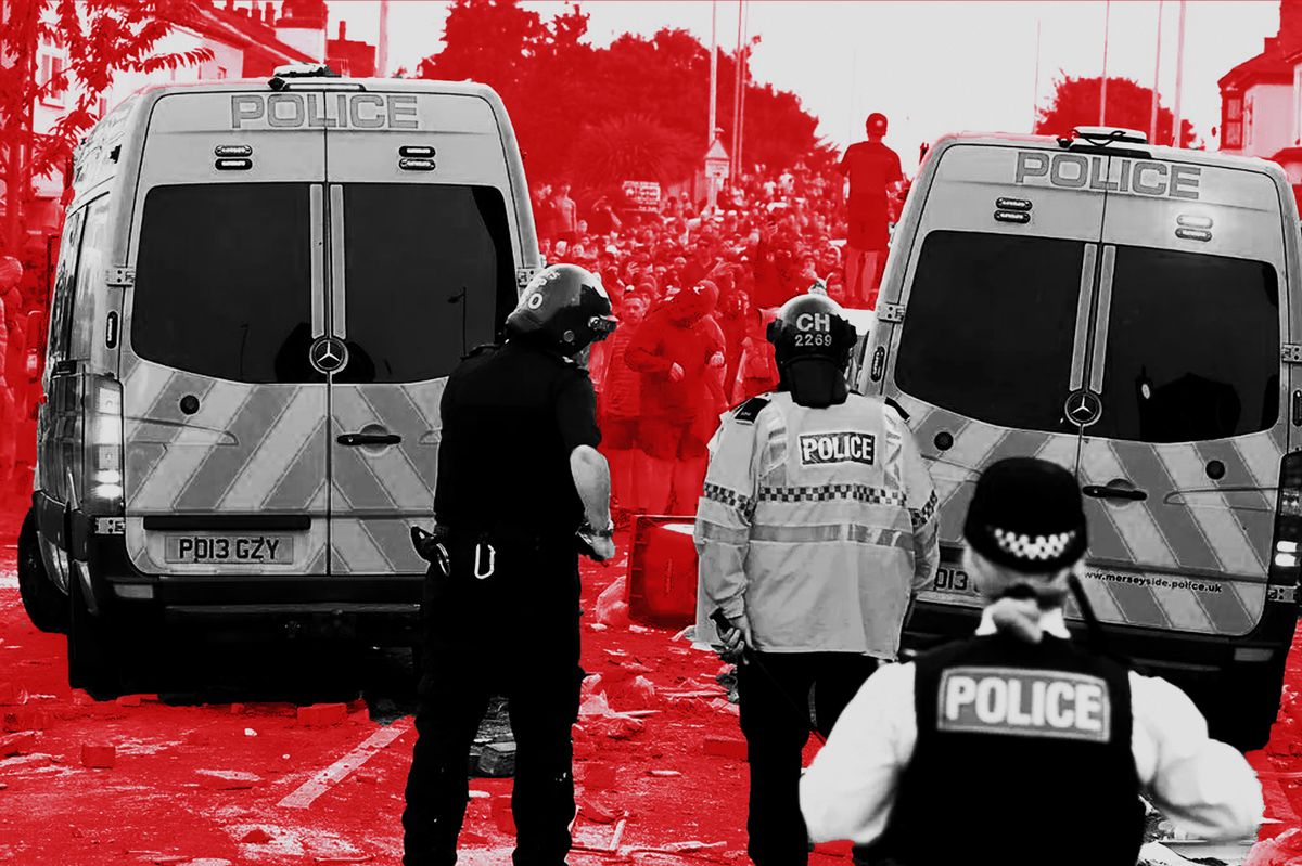 Riot police hold back protesters after disorder broke out in Southport in 2024