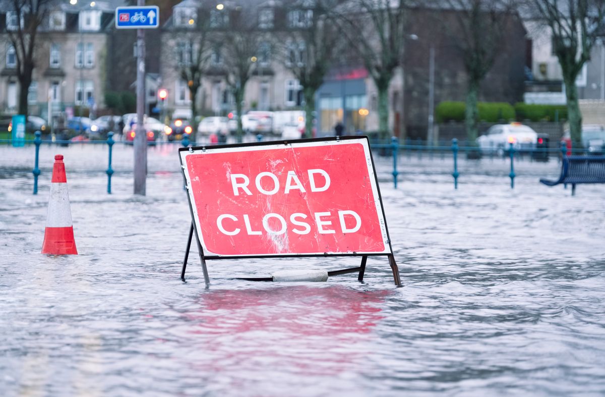 A picture of Road flood closed sign under deep water