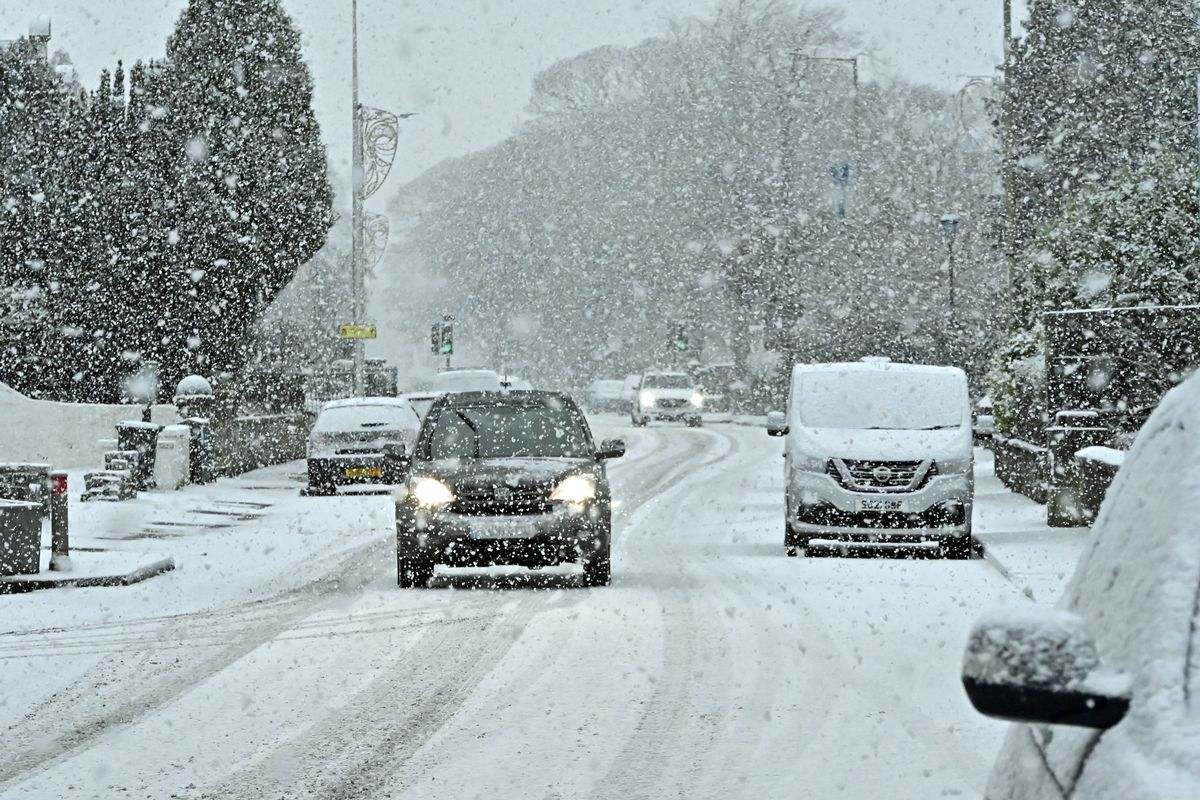 KINROSS, SCOTLAND - DECEMBER 27: Cars drive through falling snow as winter weather continues to grip parts of Scotland, on December 27 2022, in Kinross, Scotland.(Photo by Ken Jack/Getty Images)