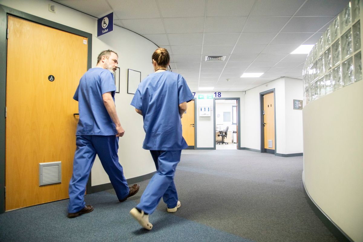 Two nurses walking through hospital
