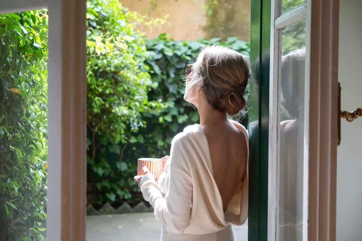 Woman looking up at the sunshine
