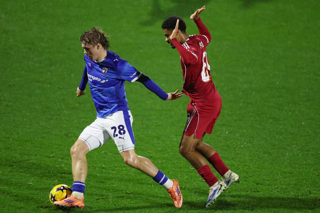 James Berry of Chesterfield is put under pressure by Kyle Kelly of Liverpool during a Vertu Trophy game.