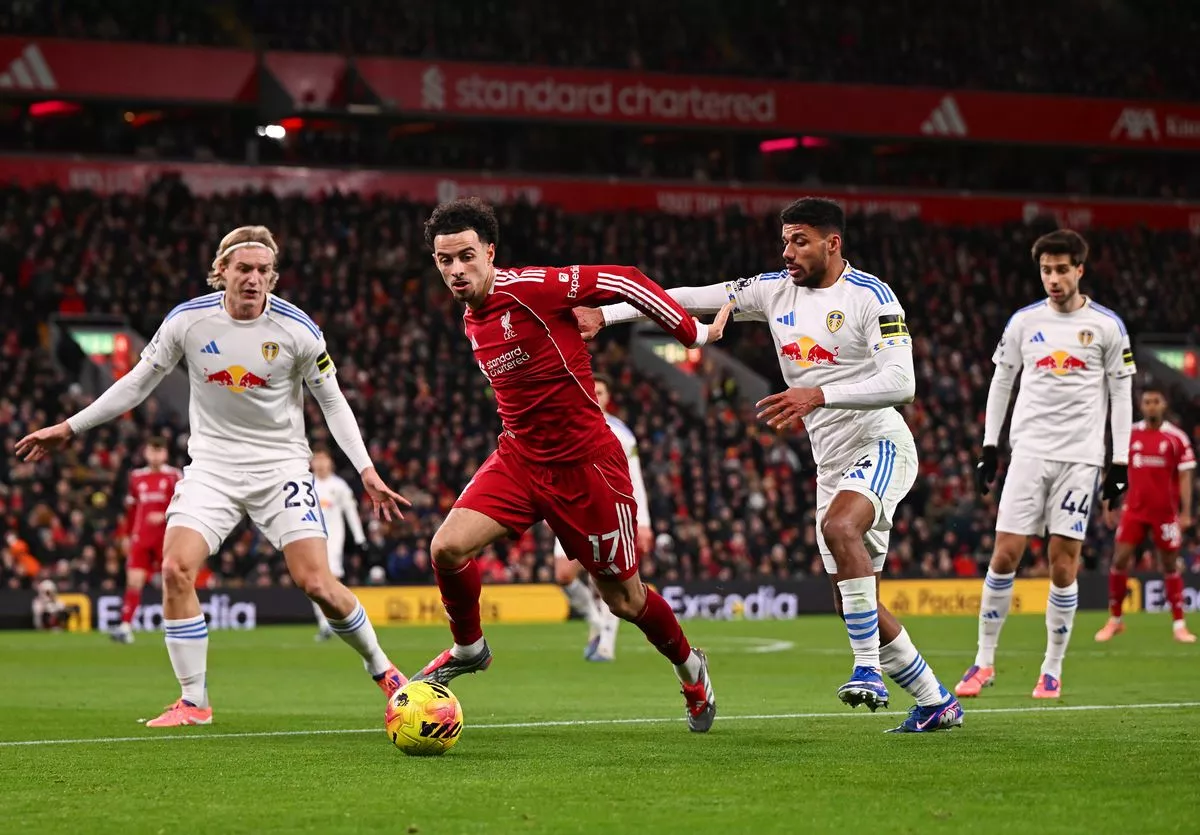 LIVERPOOL, ENGLAND - JANUARY 01: (THE SUN OUT, THE SUN ON SUNDAY OUT) Curtis Jones of Liverpool is challenged by Sebastiaan Bornauw and James Justin of Leeds United during the Premier League match between Liverpool and Leeds United at Anfield on January 01, 2026 in Liverpool, England. (Photo by Liverpool FC/Liverpool FC via Getty Images)