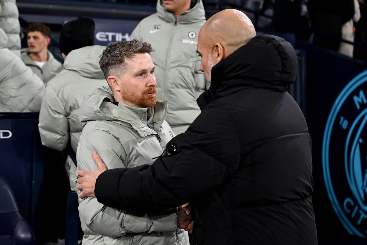 Calum McFarlane, Interim Manager of Chelsea, and Pep Guardiola, Manager of Manchester City, shake hands prior to the Premier League match between Manchester City and Chelsea at Etihad Stadium on January 04, 2026 in Manchester, England