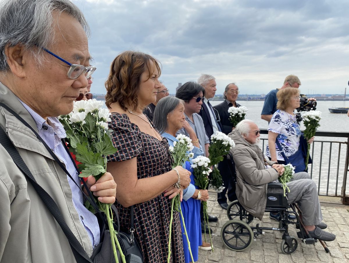 Descendants of Merseyside's lost Chinese seamen lay flowers at the memorial for the deported seamen at the Pier Head