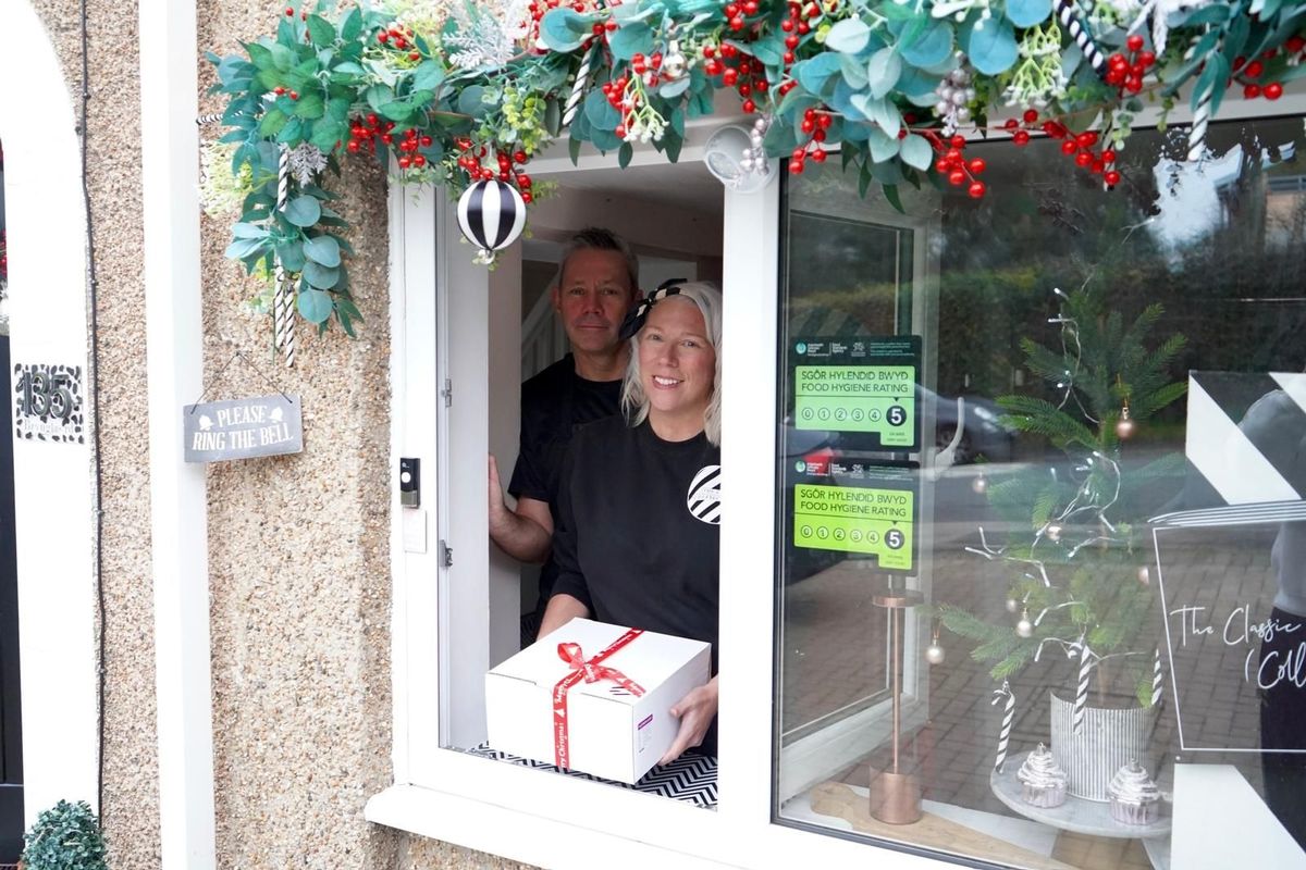 Customers collect their orders from this window at the front of their Newport home.