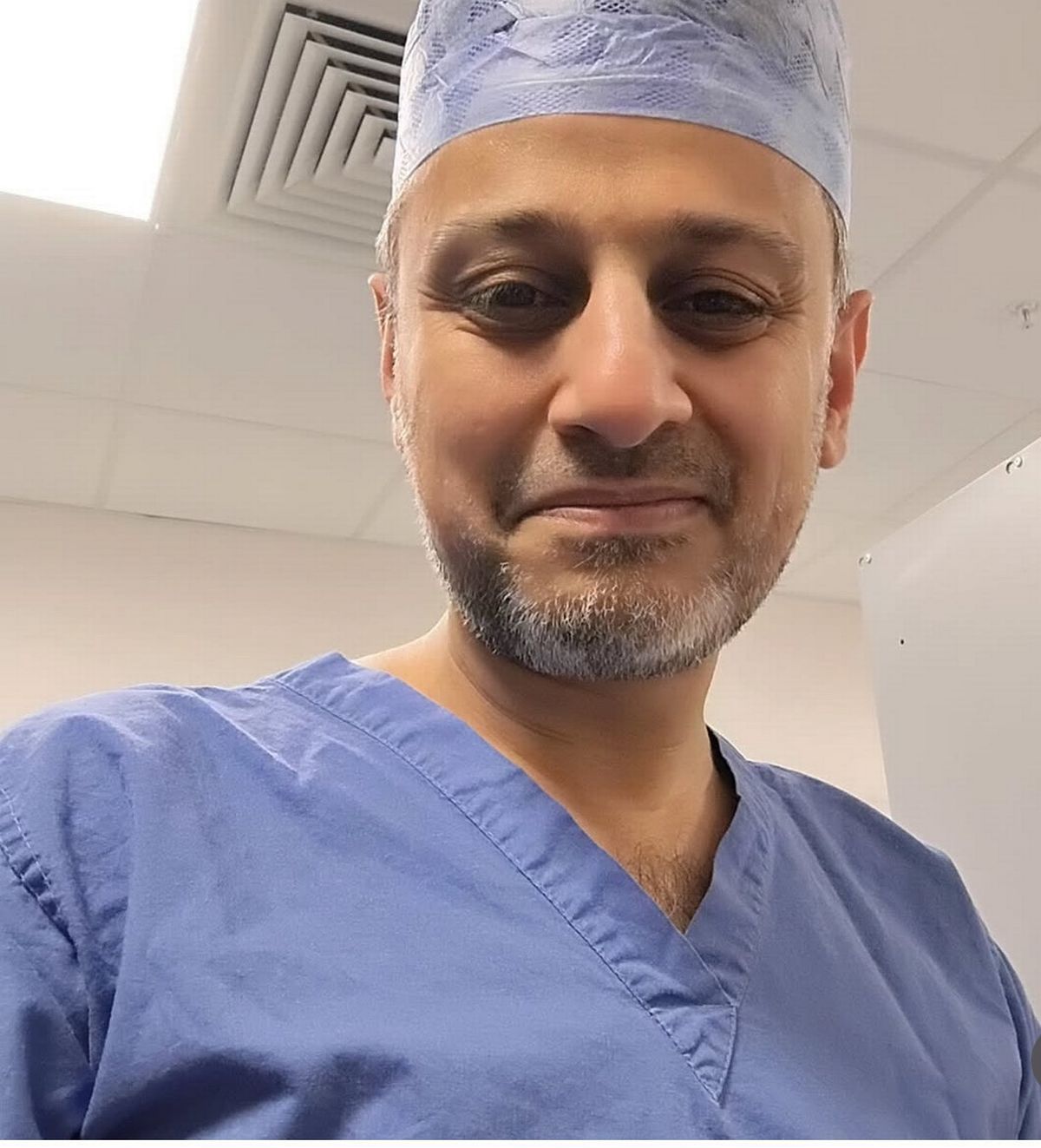 Minister Zubir Ahmed in his scrubs