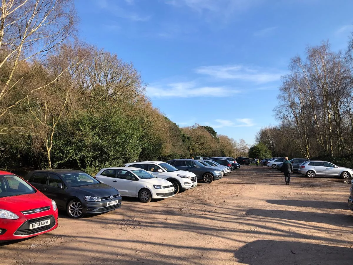 A car park with vehicles parked in Sutton Park 