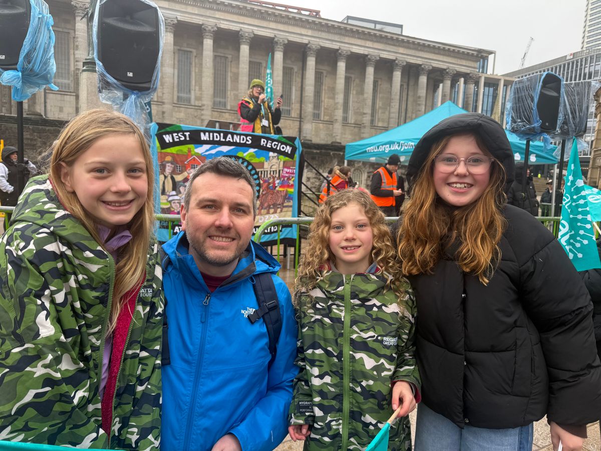 Parent Mark Lewis and his daughters supported teachers on strike this morning