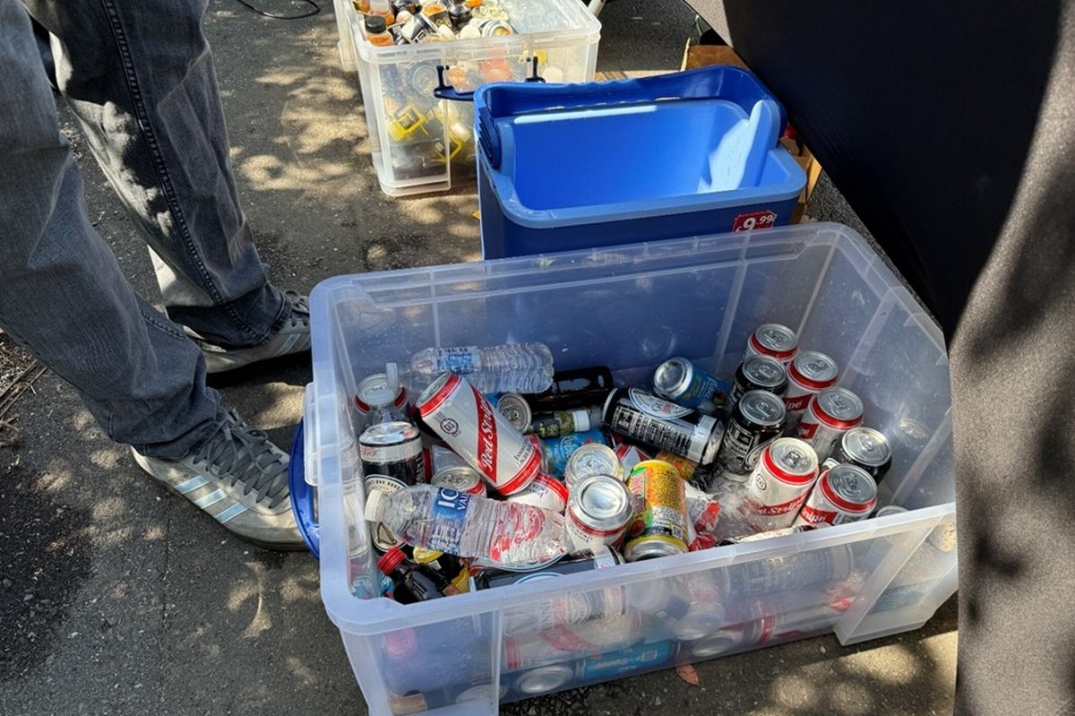 Cans of beers and spirits in plastic boxes on the pavement from which they were illegally being sold