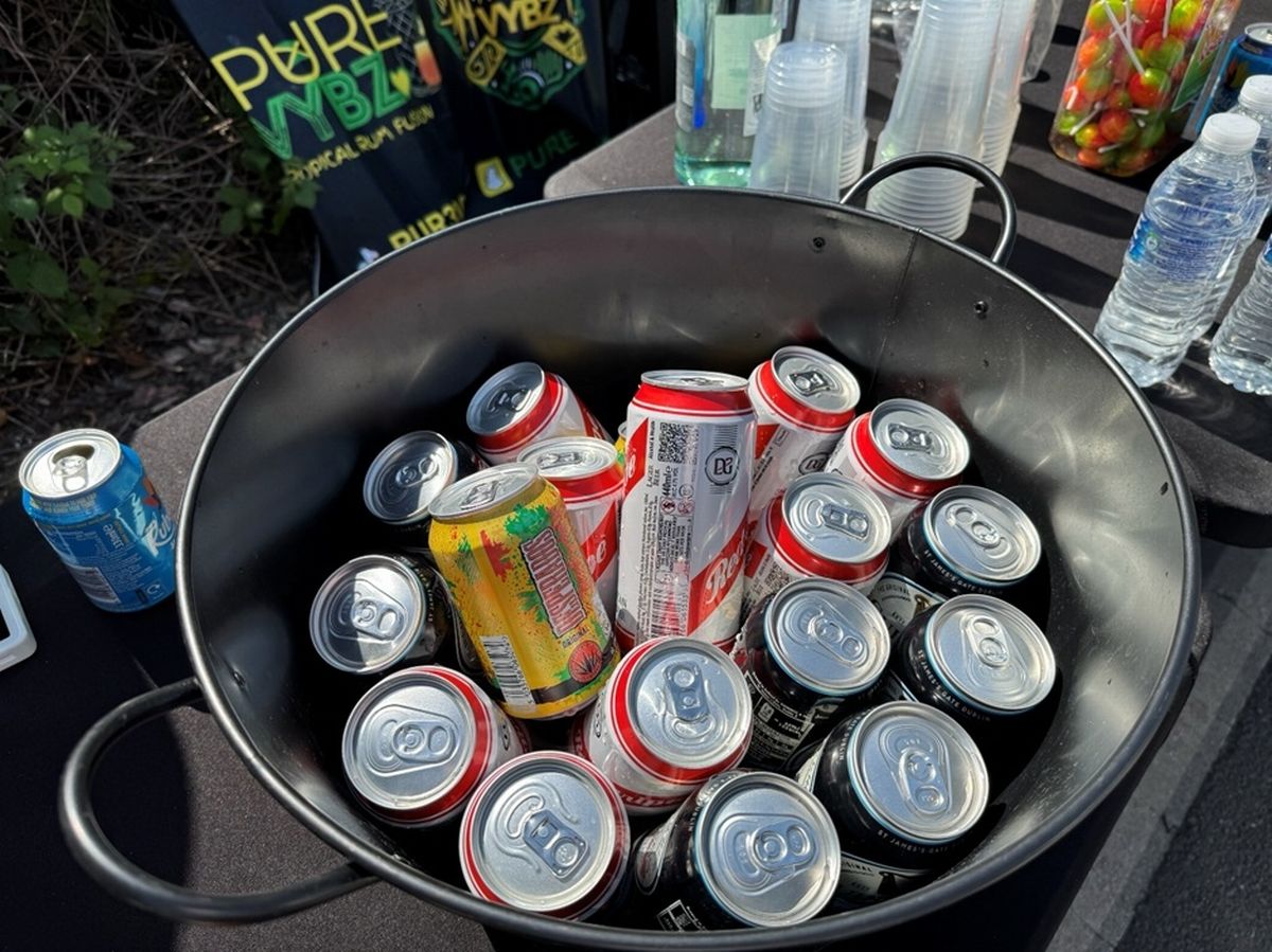 Cans of beer in iced water in a bucket from which they were being sold