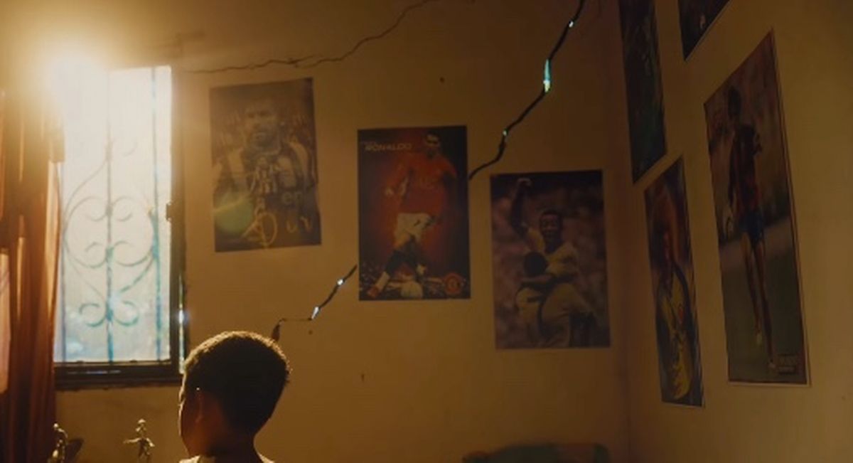 A poster of Cristiano Ronaldo appears on the wall