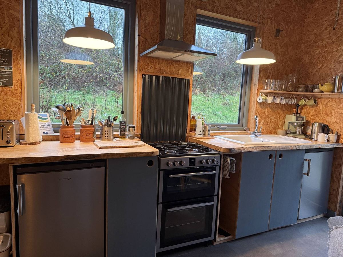 Kitchen facilities inside the communal kitchen mean groups can cook together at Under Starry Skies holiday retreat near Llandeilo