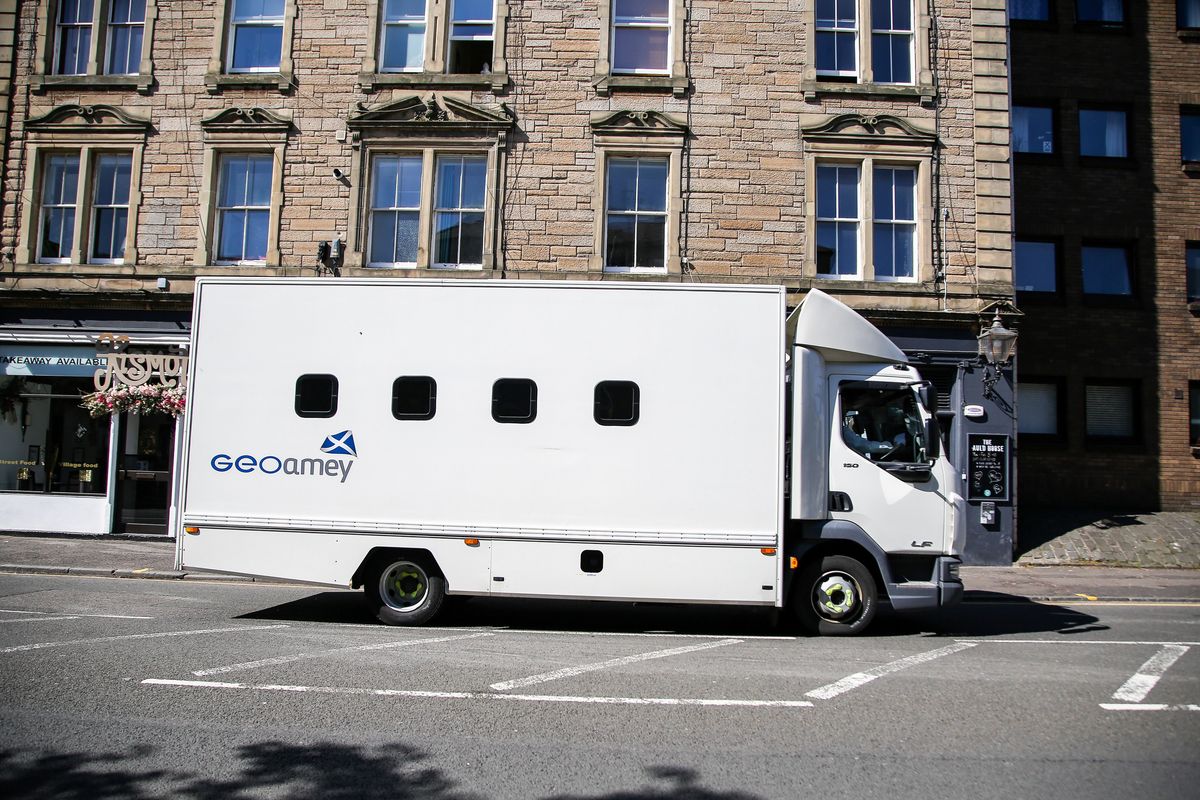 An image of a large white van with porthole windows.