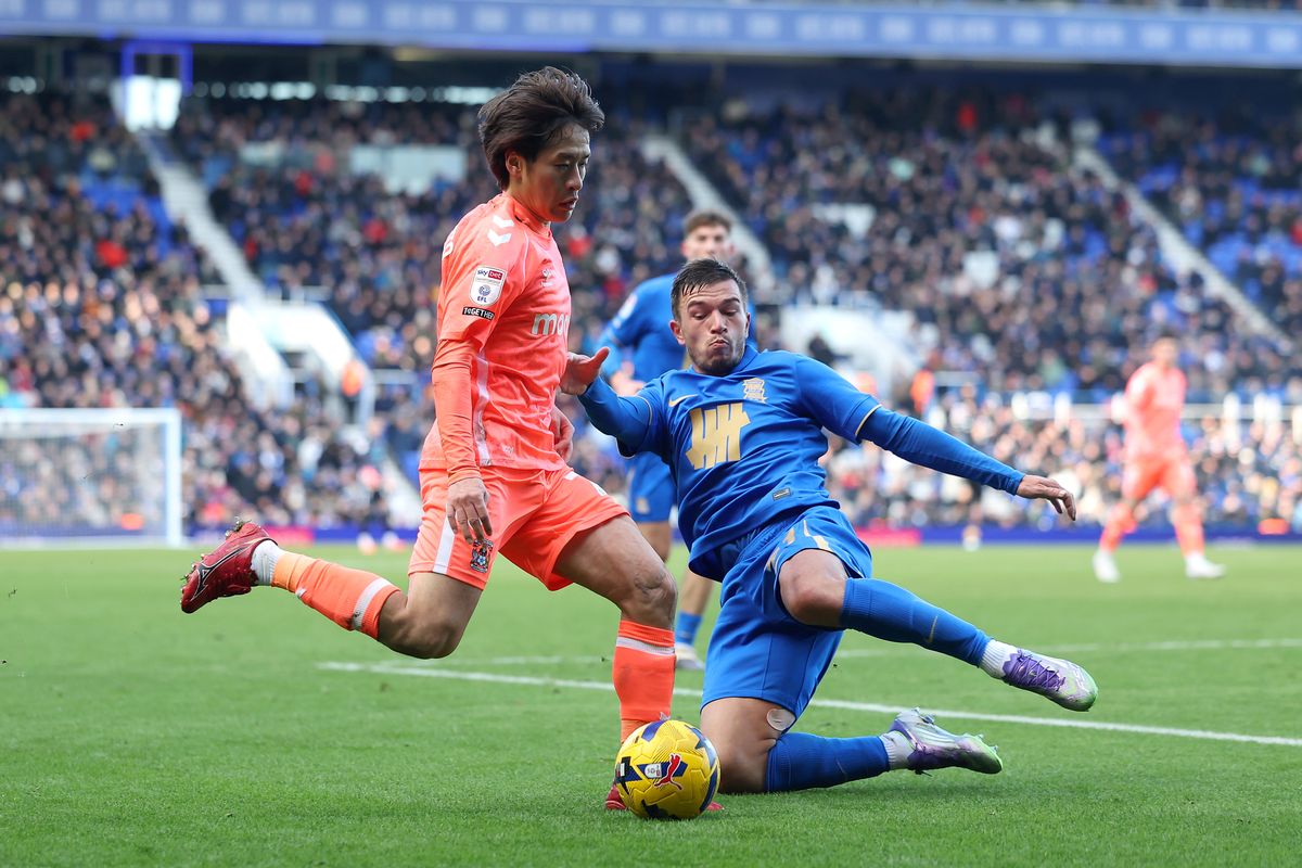 Tatsuhiro Sakamoto of Coventry City is tackled by Kai Wagner of Birmingham City