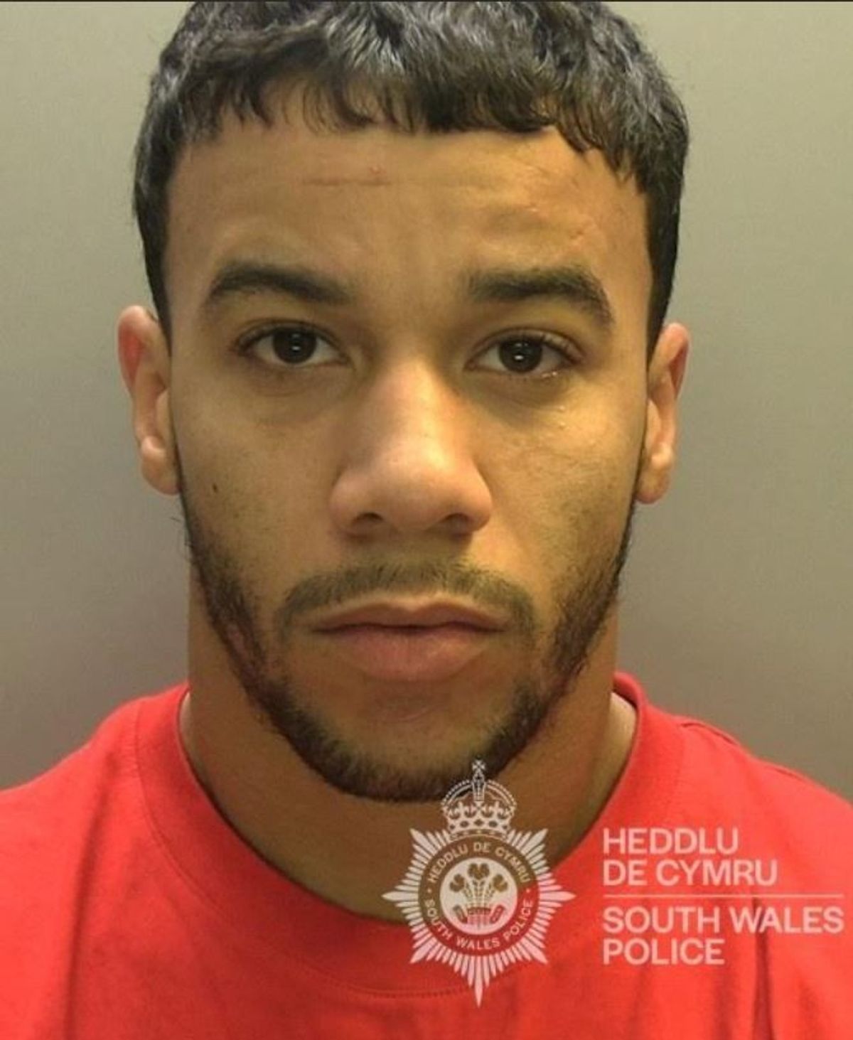 A man with dark olive complexion, dark hair and short facial hair