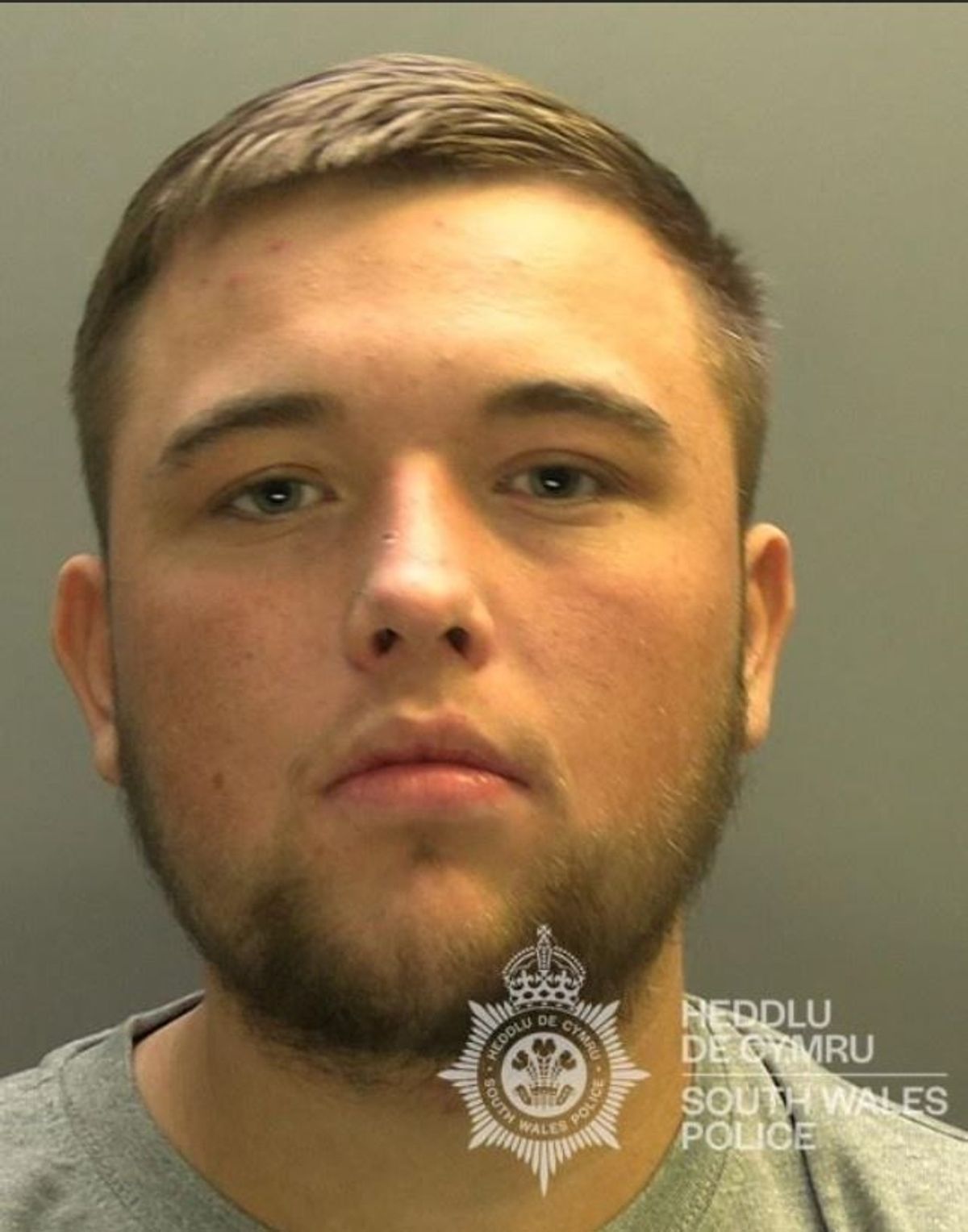 White man with short brown hair and facial hair