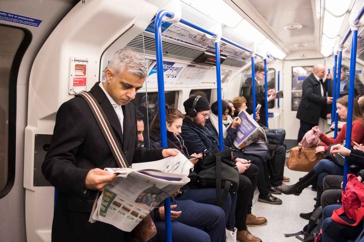 Sadiq Khan reading a newspaper on the Tube