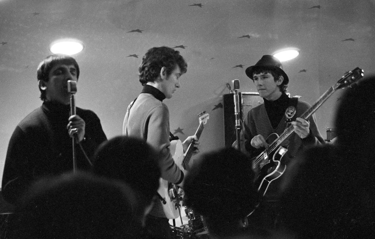 Black and white photo of musicians on stage above a heaving crowd. All Nite Beat Boat at the Royal Iris in April 1965.