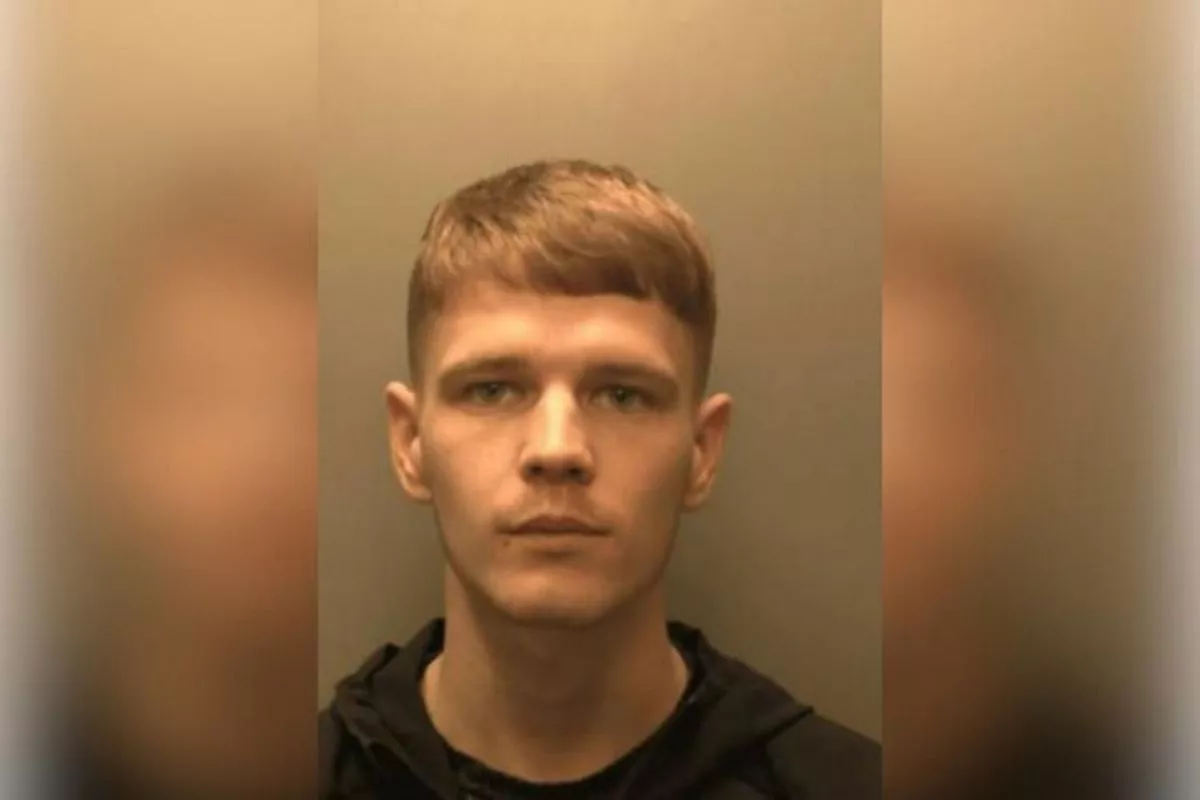 Custody photo of James Liddle, 23, who has blonde hair, and is wearing a black coat and black t-shirt.