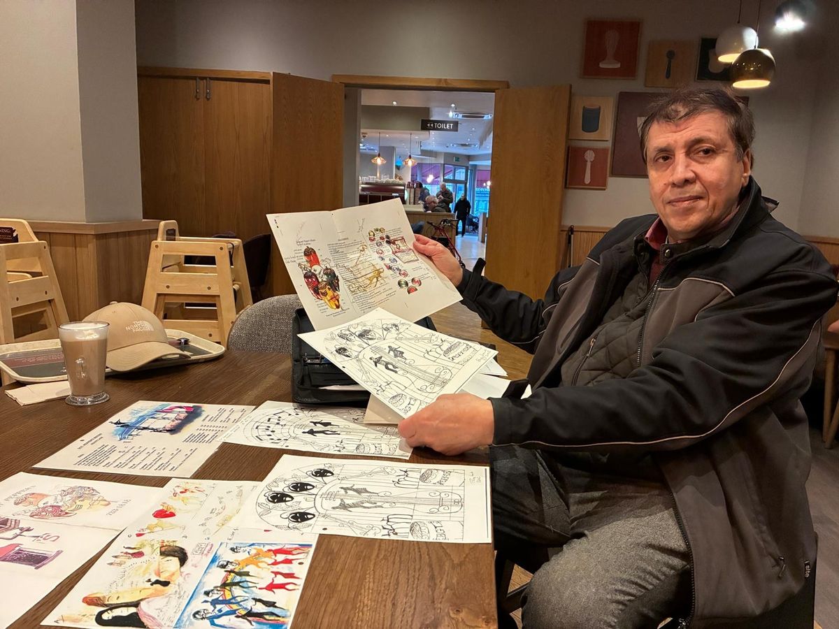 Ray Maatook with 2003 artist's impressions of his closed Sergeant Pepper's Bistro.