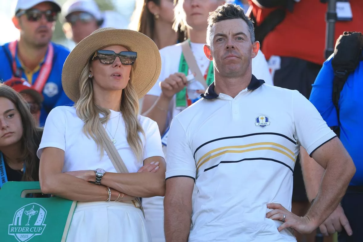 FARMINGDALE, NEW YORK - SEPTEMBER 28:   Rory McIlroy of Europe looks on with his wife Erica by the 17th green during the Sunday singles matches of the 2025 Ryder Cup at Black Course at Bethpage State Park Golf Course on September 28, 2025 in Farmingdale, New York. (Photo by David Cannon/Getty Images)
