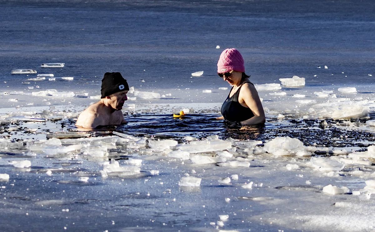 Swimmers take to the frozen water