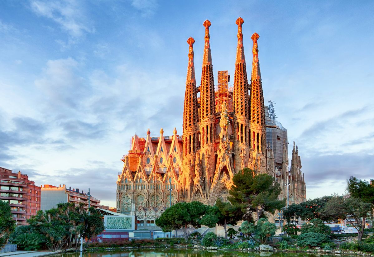 Barcelona, Spain - February 10th, 2016: Tourists at backside of famous church and cathedral Sagrada Familia in Barcelona. Seen from subway station Sagrada Familia. Church also called Temple Expiatori de la Sagrada FamÃlia - famous basilica built by Antoni Gaudi in year 1882 and til today not finished. Church is located in district Eixample in North of town. Some parts of church are UNESCO World Heritage.