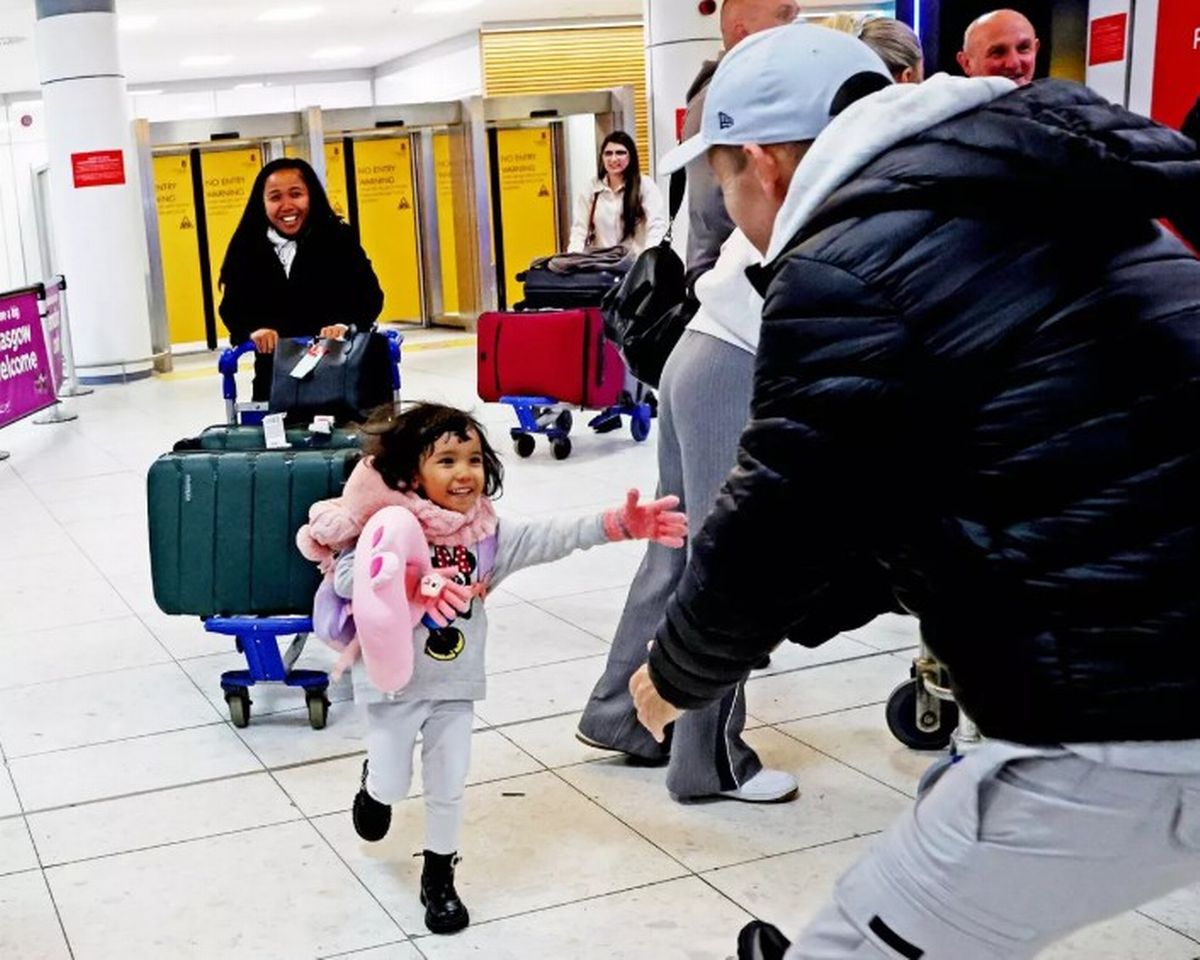 Adrian reuniting with his family at the airport