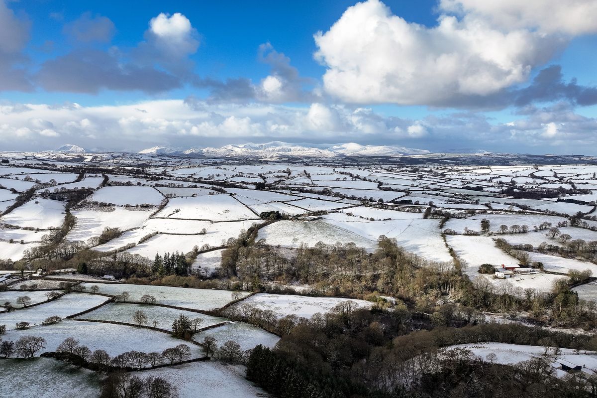 Aerial view, near Llanrwst, snow covers the high ground of North Wales and Snowdonia 