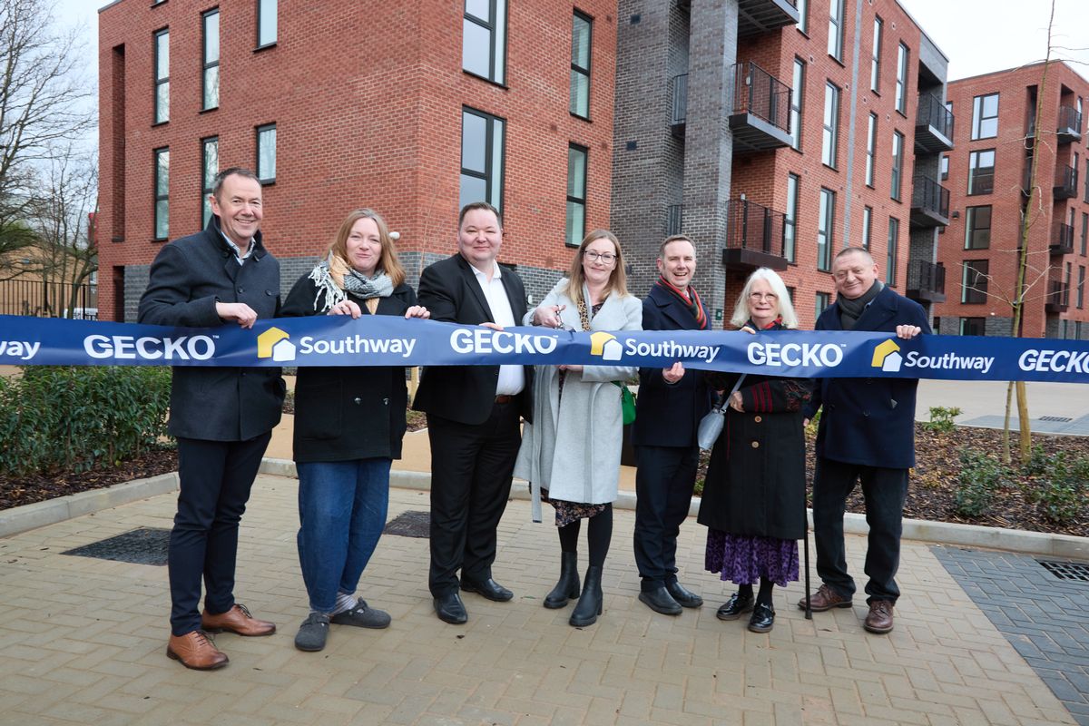 Resident Elaine cuts the ribbon watched by John Bowker, Southway Housing Trust Chief Executive, Coun Sarah Haughey (Longford), Andrew Western MP for MP for Stretford and Urmston, Trafford Council Leader Tom Ross, Coun Judith Lloyd (Longford) and Coun David Jarman (Longford)