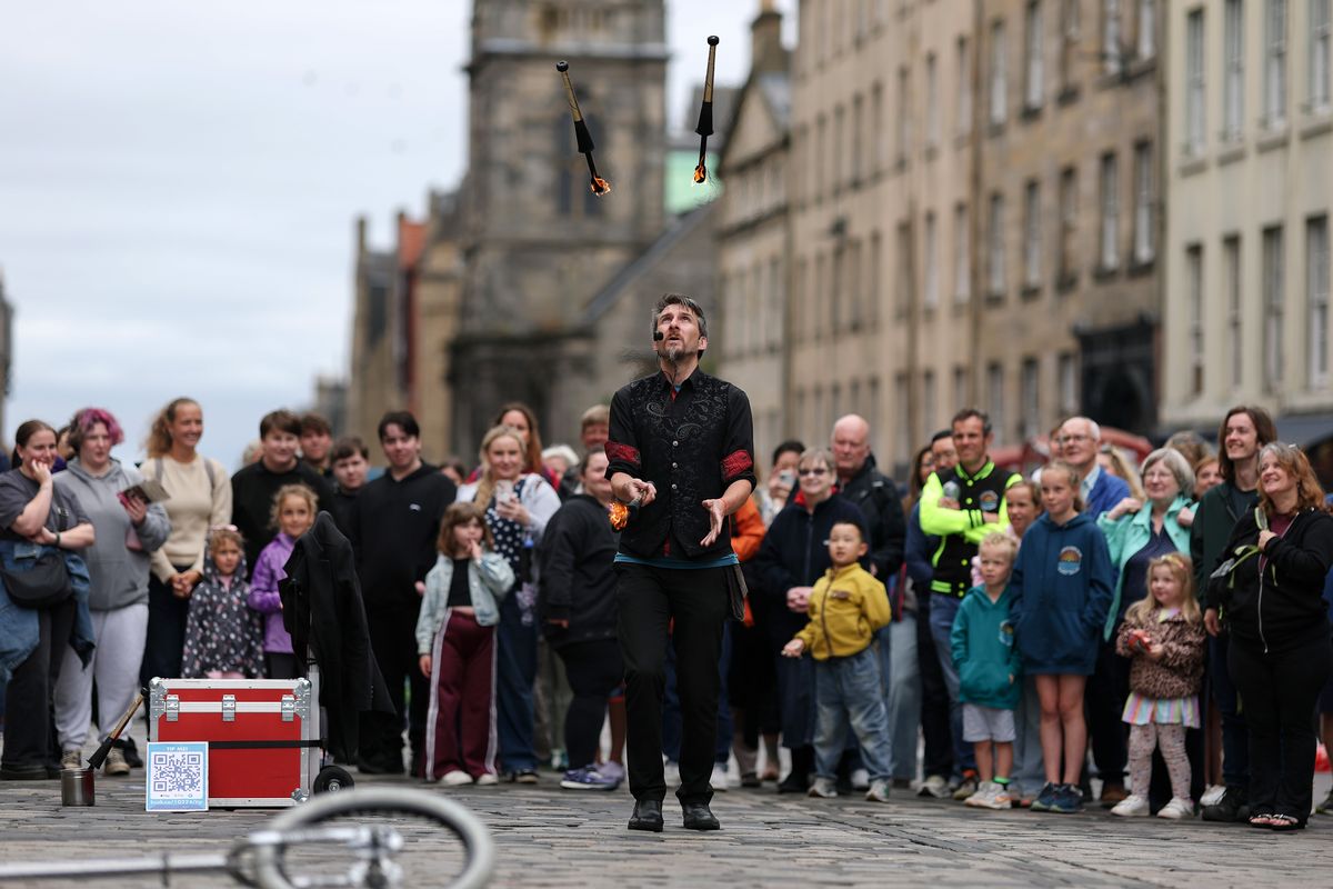  Street entertainers perform on Edinburgh's Royal Mile during the city's Festival Fringe on August 19, 2025
