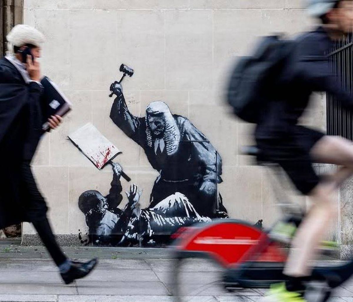 Images showing a new work of art by Banksy, revealed on the Bristol street artist's Instagram page on August 8, 2025, showing a judge beating a protester with his gavel, on the walls of the Royal Courts of Justice in London