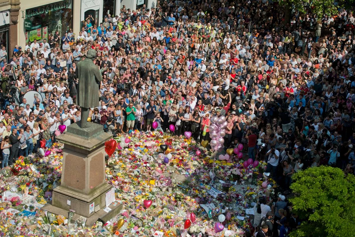 Mourners pay their respects to the Manchester Arena bombing victims in 2017