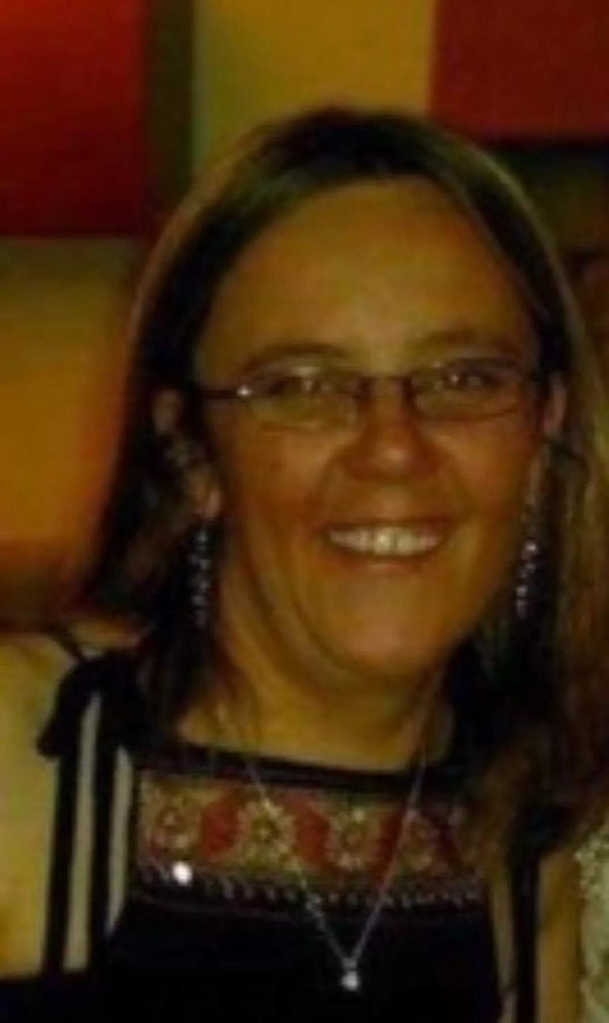 A picture of a smiling Stephanie Davies, wearing glasses, before her death