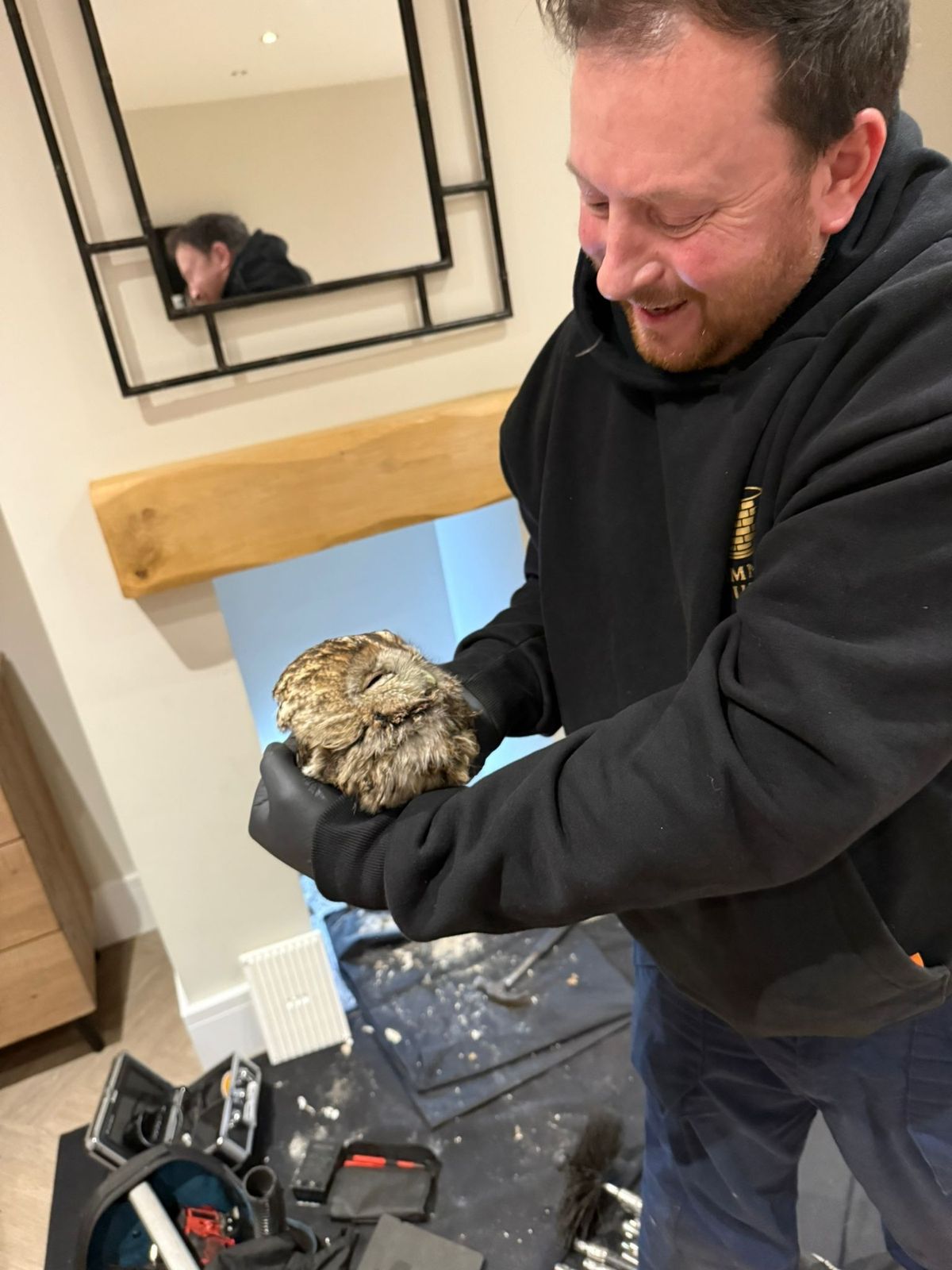 Grimsby chimney sweep Michael Nolan with the rescued owl 