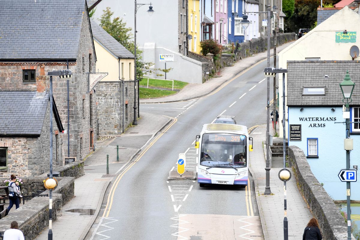 A bus travelling along a residential road