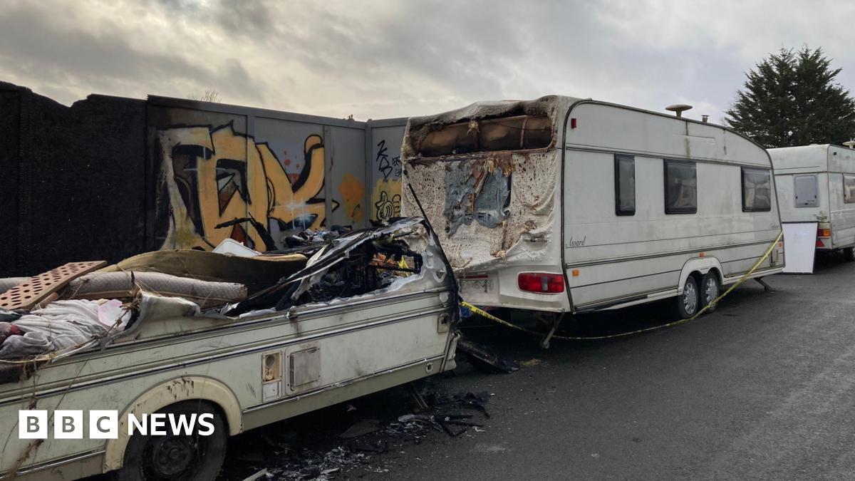 Prime Minister Mark Carney, wearing a black suit jacket, and a white button-up shirt leans his chin on his hands. He has short grey and black hair and is looking away from the camera.