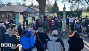 A group of people standing outside Ifield Golf Club as part of a protest against its proposed closure.