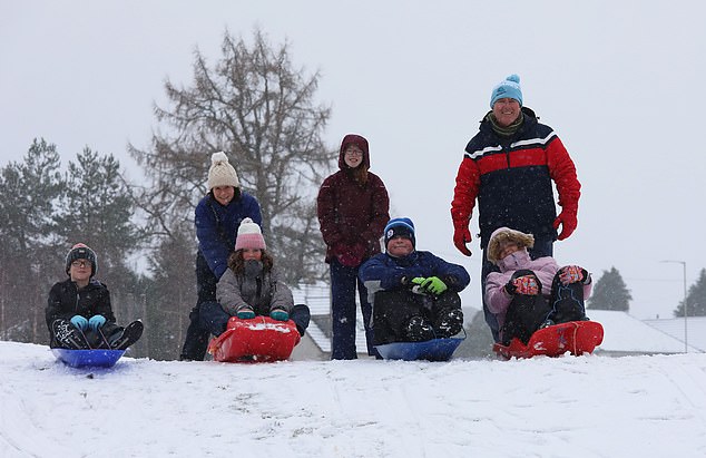 Families have fun in the snow in Carrbridge in the Scottish Highlands