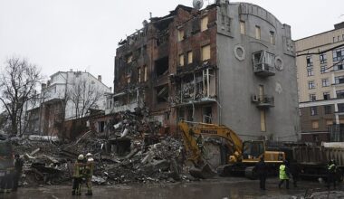 Rescuers work to find bodies amongst the rubble of an apartment block in Kharkiv, Ukraine, on January 3