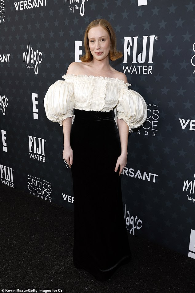 Hannah Einbinder struck a romantic note in a dramatic gown featuring an ivory ruched bodice with exaggerated puff sleeves, paired with a high-waisted black skirt