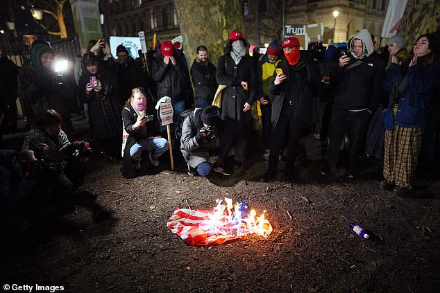 An American flag was set alight and stamped on outside Downing Streetas campaigners against Donald Trump's capture of Nicolas Madurochanted 'death, death to the USA'