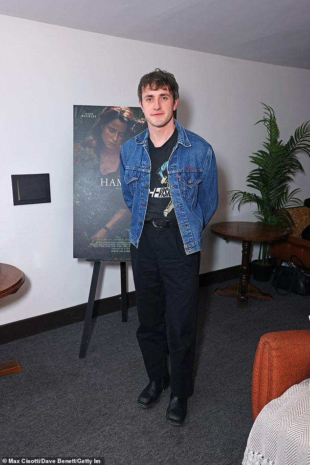 Paul cut a casual figure for the event in a denim shirt and navy trousers